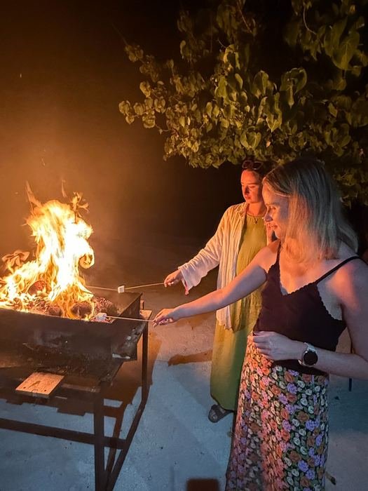 Grilling by the fire on the beach after dark